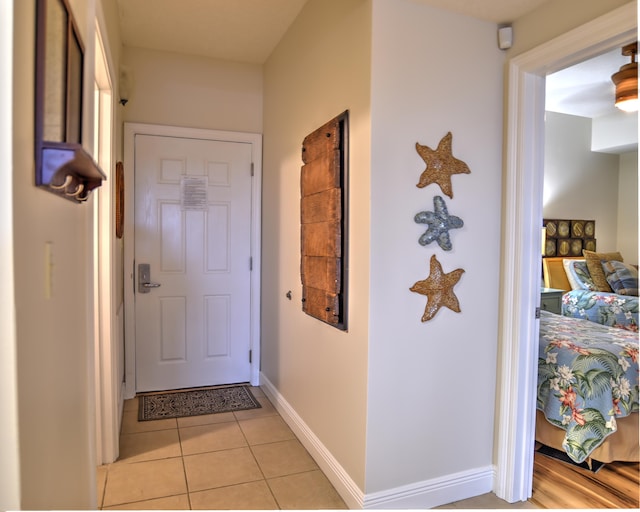 doorway to outside featuring light tile flooring