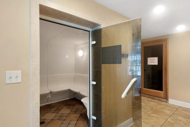 bathroom with a shower with door and tile floors