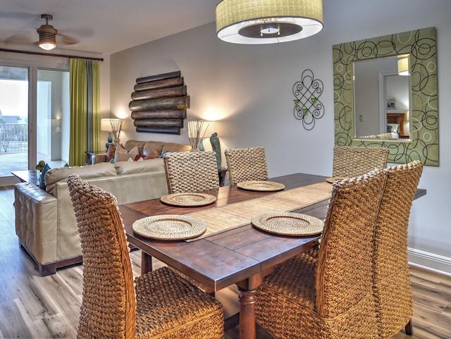 dining space with light hardwood / wood-style flooring and ceiling fan