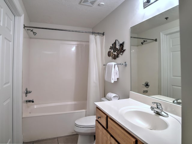 full bathroom featuring toilet, shower / tub combo with curtain, a textured ceiling, vanity, and tile floors