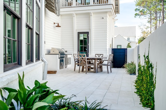 view of terrace featuring area for grilling and an outdoor kitchen