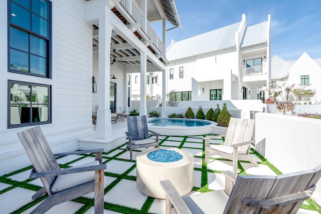 view of terrace with ceiling fan and a balcony