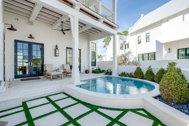 view of swimming pool with a patio area and french doors