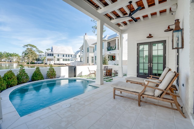 view of swimming pool with french doors and a patio