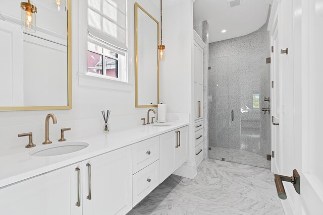 bathroom featuring a shower with door, tile flooring, and dual vanity