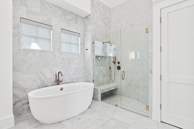 bathroom with shower with separate bathtub, tile flooring, and tile walls