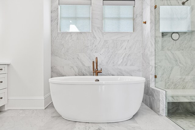 bathroom featuring vanity, tile floors, and tile walls