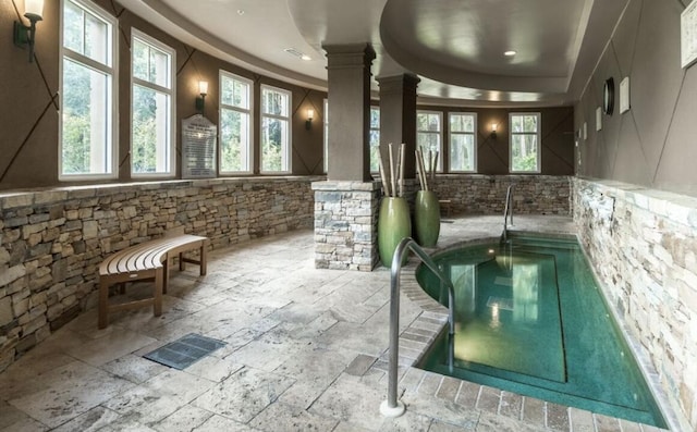 interior space with an indoor hot tub and ornate columns