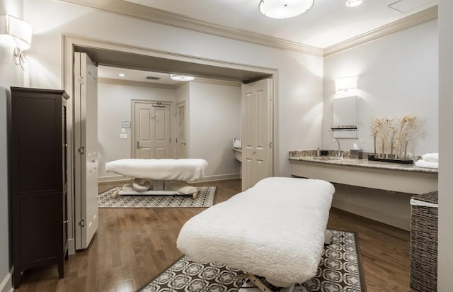 bathroom featuring sink, crown molding, and wood-type flooring