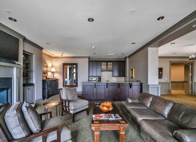 living room featuring ornamental molding and built in shelves