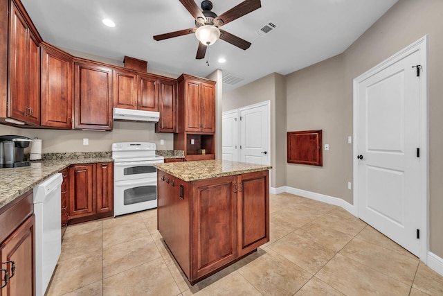 kitchen featuring white appliances, ceiling fan, light stone countertops, light tile patterned floors, and a kitchen island