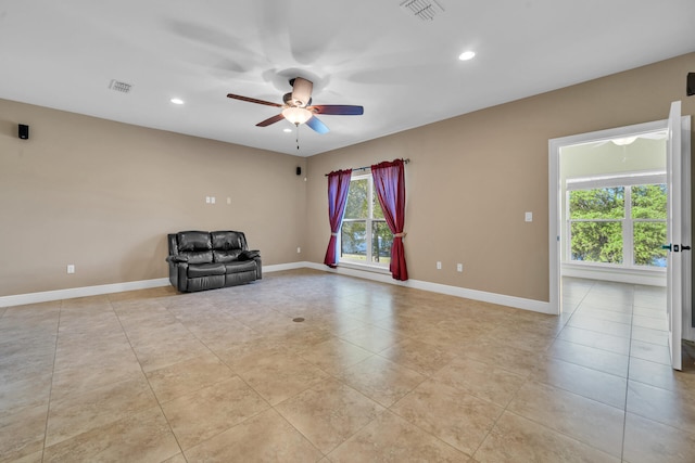 unfurnished room featuring ceiling fan and light tile patterned floors