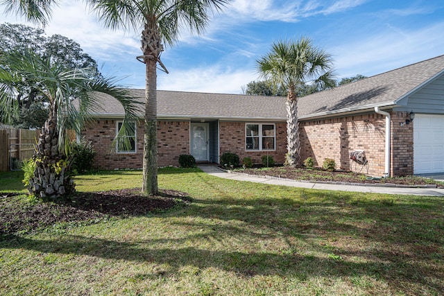 single story home featuring a garage and a front yard