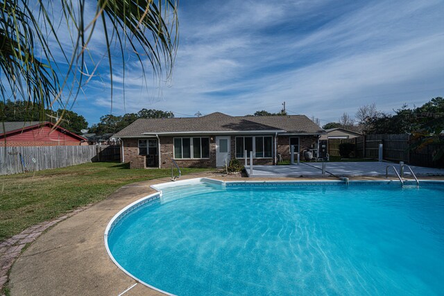 view of swimming pool with a lawn and a patio area