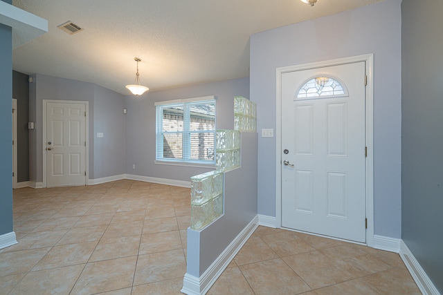 tiled entrance foyer with a wealth of natural light and a textured ceiling