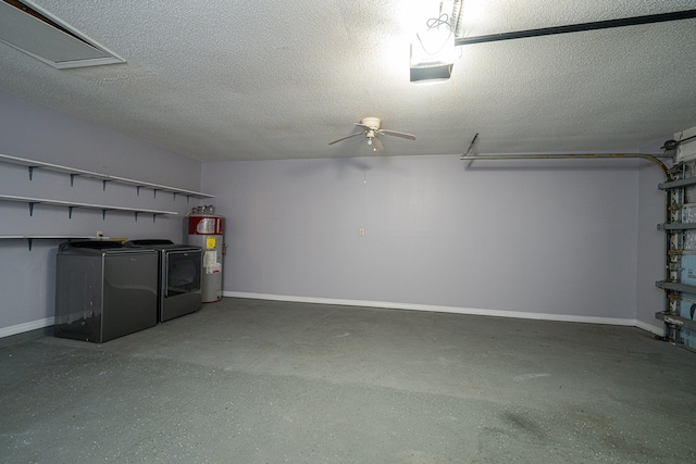 garage featuring washing machine and dryer, ceiling fan, and electric water heater