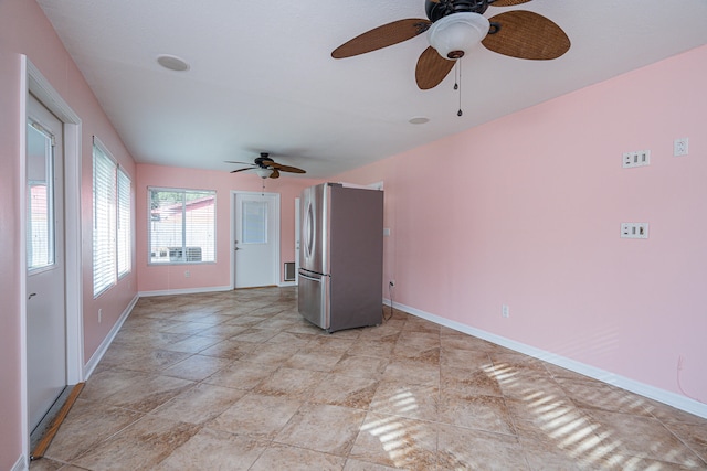 empty room featuring ceiling fan and light tile floors