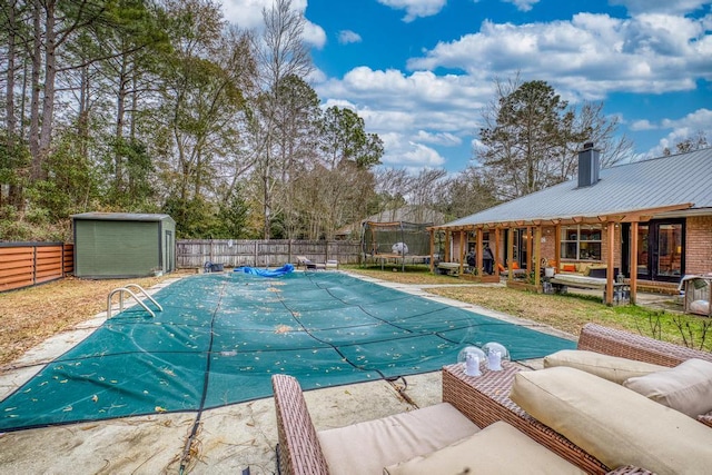 view of pool featuring a trampoline, a storage shed, outdoor lounge area, and a patio