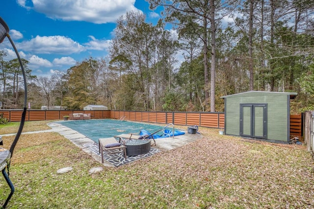 view of swimming pool with a patio area and a storage shed