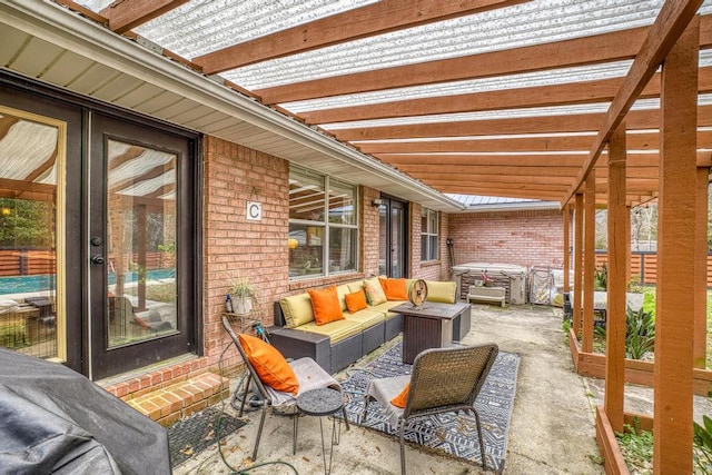 view of patio / terrace featuring an outdoor living space, a hot tub, and a pergola