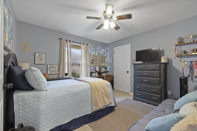 bedroom with light carpet, a textured ceiling, and ceiling fan