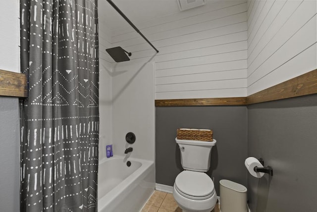 bathroom featuring shower / tub combo with curtain, toilet, and tile patterned flooring