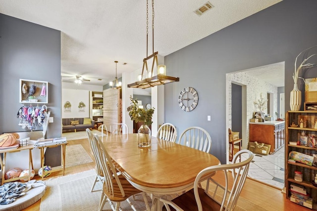 dining room with ceiling fan and light hardwood / wood-style flooring