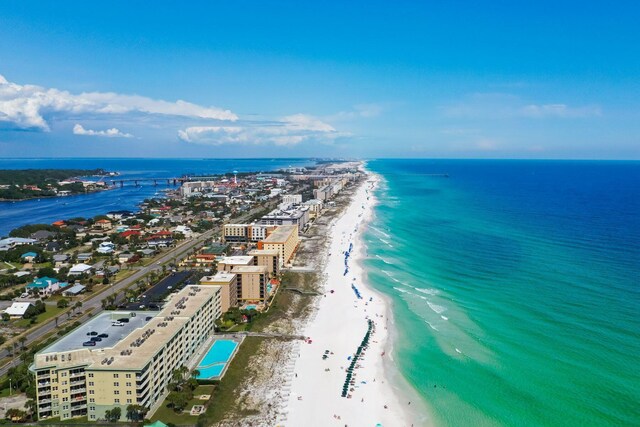 drone / aerial view featuring a water view and a beach view