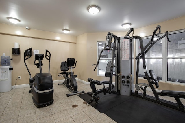 workout room with light tile patterned flooring