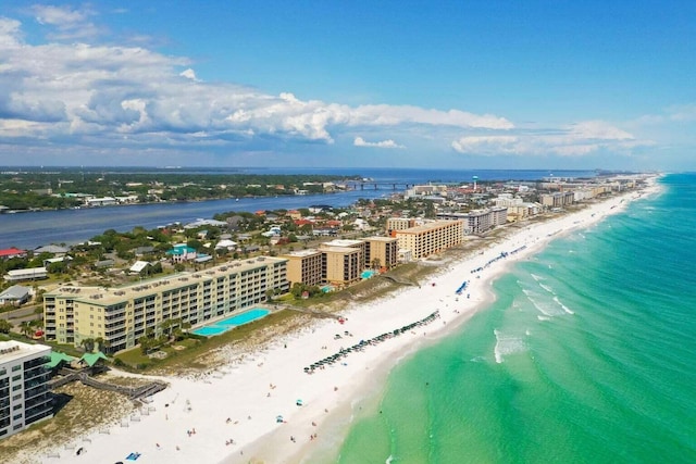 birds eye view of property with a water view and a beach view