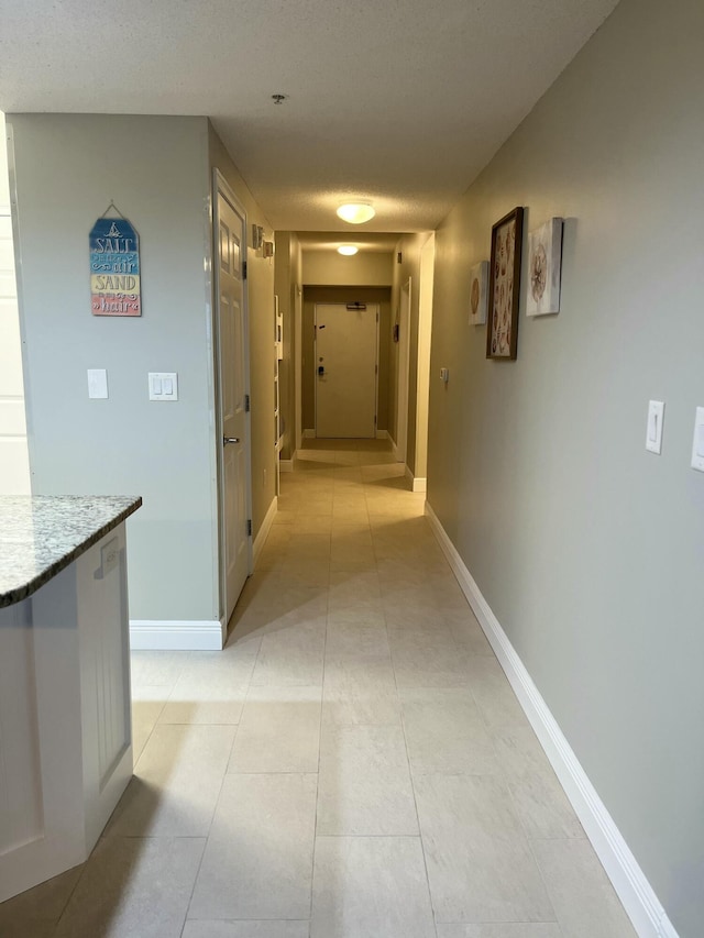 corridor with a textured ceiling