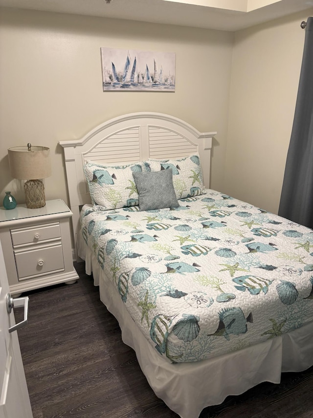 bedroom with dark hardwood / wood-style floors