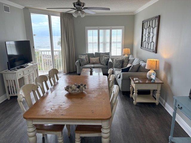 dining area featuring a wealth of natural light, ceiling fan, dark hardwood / wood-style floors, and a textured ceiling