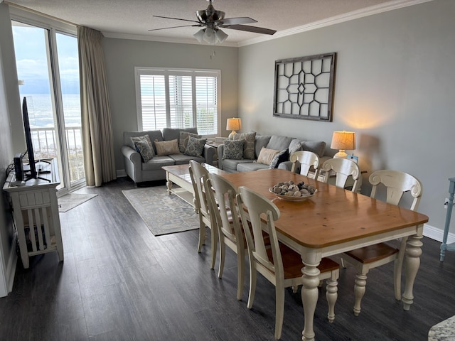 dining space featuring a textured ceiling, dark wood-type flooring, ceiling fan, and ornamental molding