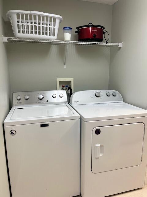 laundry area with independent washer and dryer