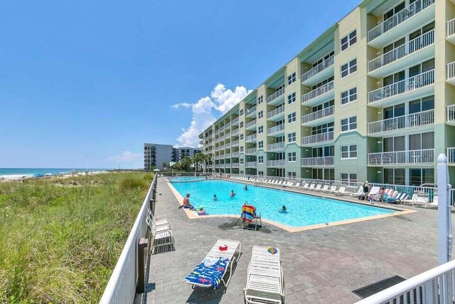 view of swimming pool with a water view