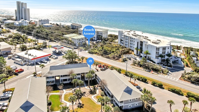 birds eye view of property with a water view and a view of the beach