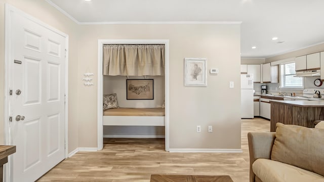 interior space featuring light hardwood / wood-style flooring and ornamental molding