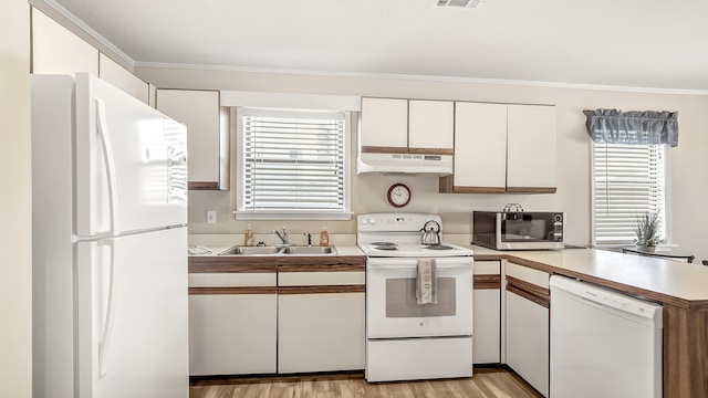 kitchen featuring a wealth of natural light, white cabinetry, white appliances, and sink