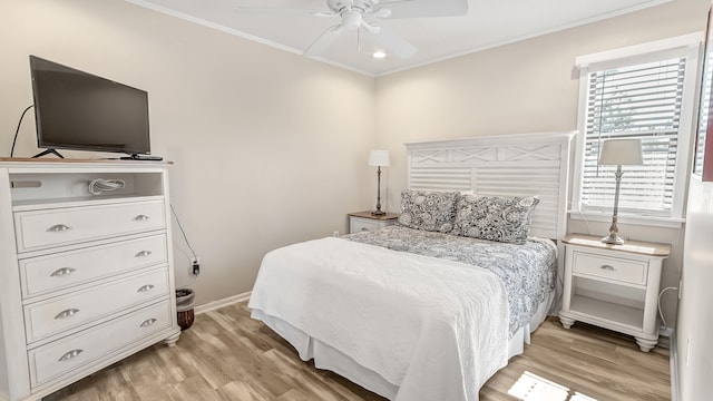 bedroom with light hardwood / wood-style flooring, ceiling fan, and ornamental molding