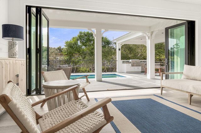 interior space featuring a fenced in pool, area for grilling, and grilling area