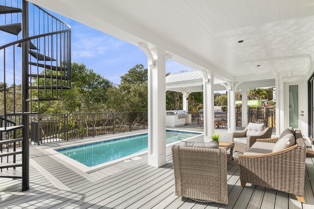 view of pool with outdoor lounge area and area for grilling