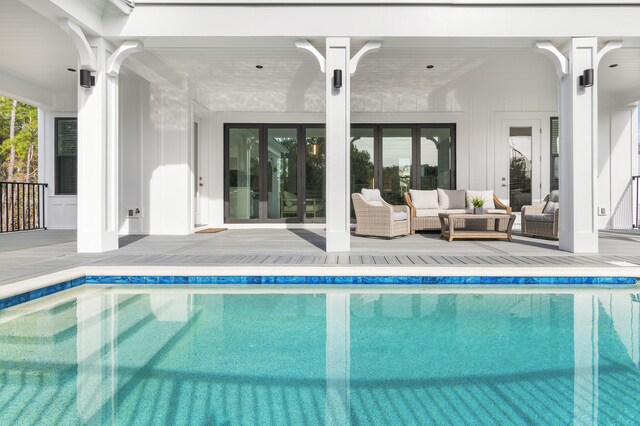 view of pool with outdoor lounge area and a patio