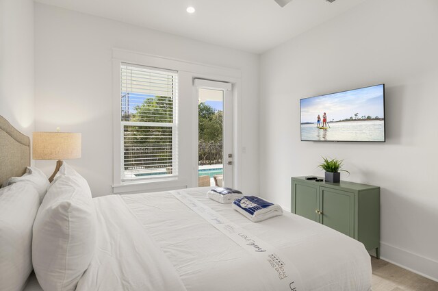 bedroom featuring access to exterior and light wood-type flooring