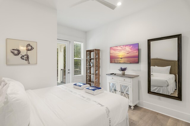 bedroom featuring access to exterior and light wood-type flooring