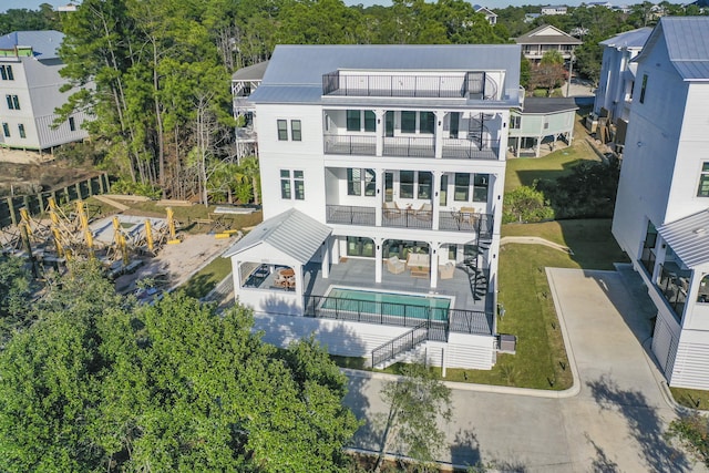 rear view of property with a patio area and a balcony