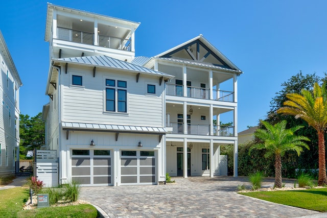 view of front facade featuring a garage and a balcony