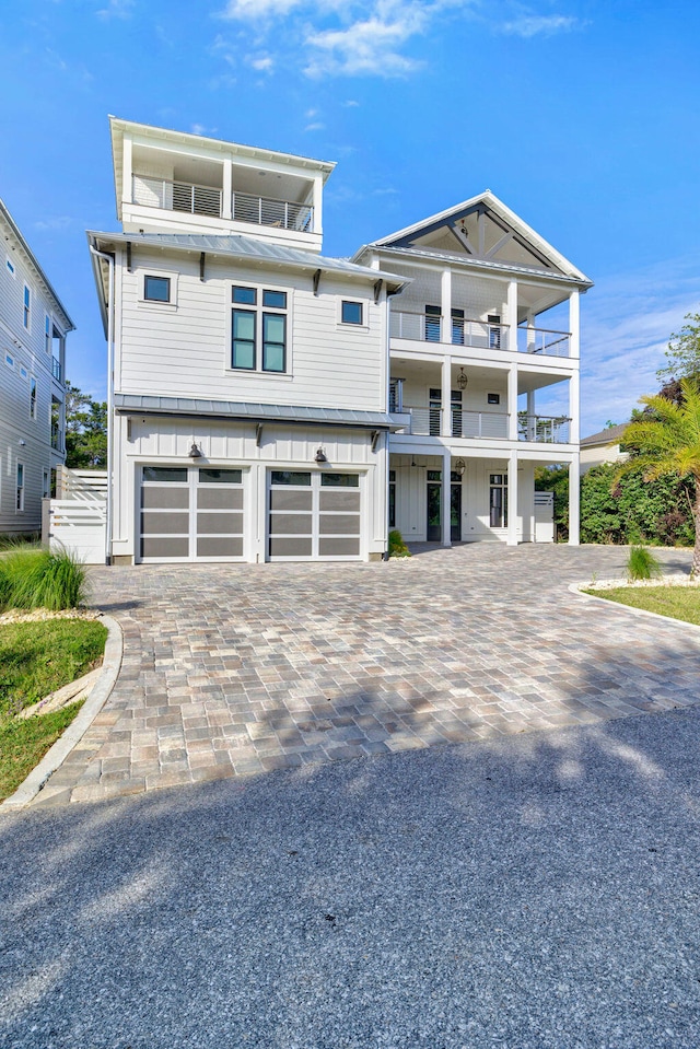 view of front of home featuring a garage and a balcony