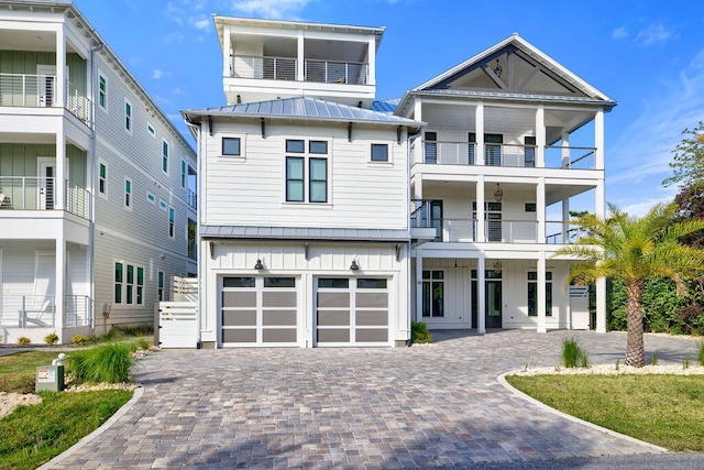 view of front facade with a garage and a balcony