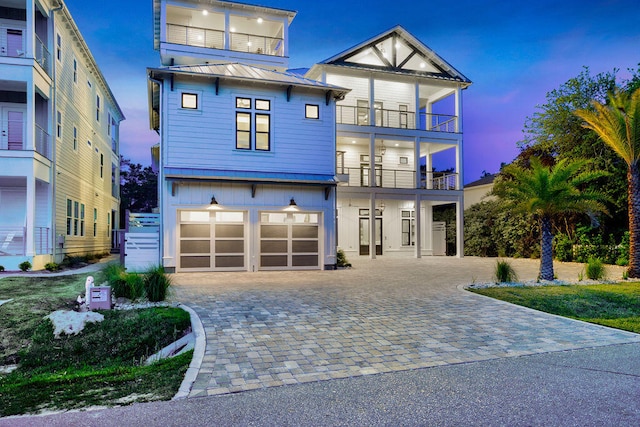 view of front of house with a garage and a balcony